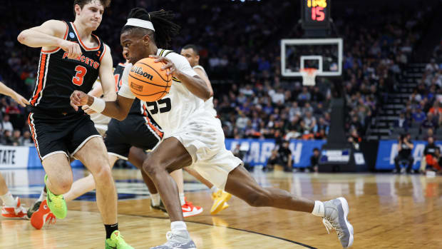 Missouri Tigers guard Sean East II dribbles past Princeton Tigers guard Ryan Langborg.